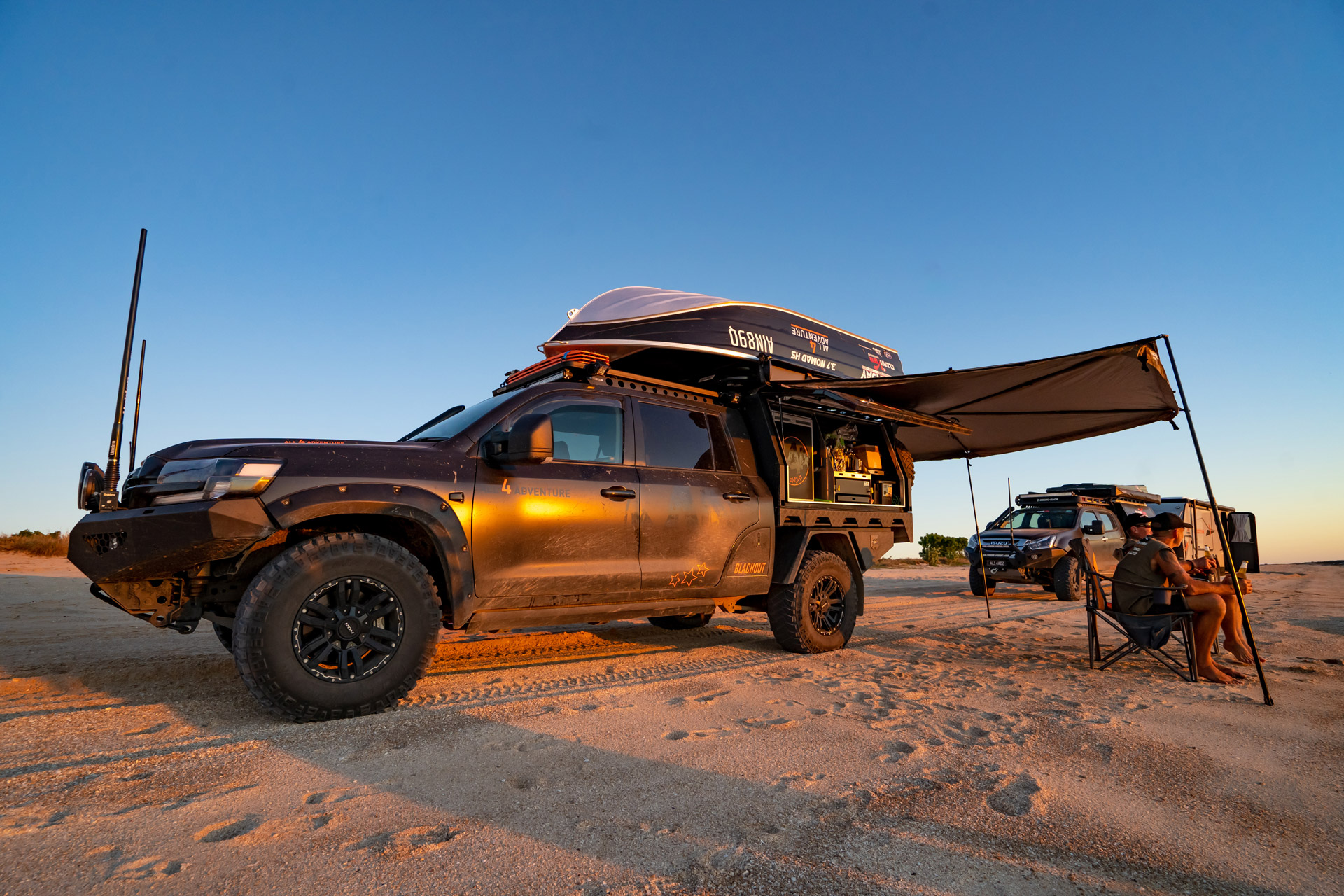 All 4 Adventure LandCruiser 200 Series with ROH Vapour wheels on the beach at sunset with Jase and Simon